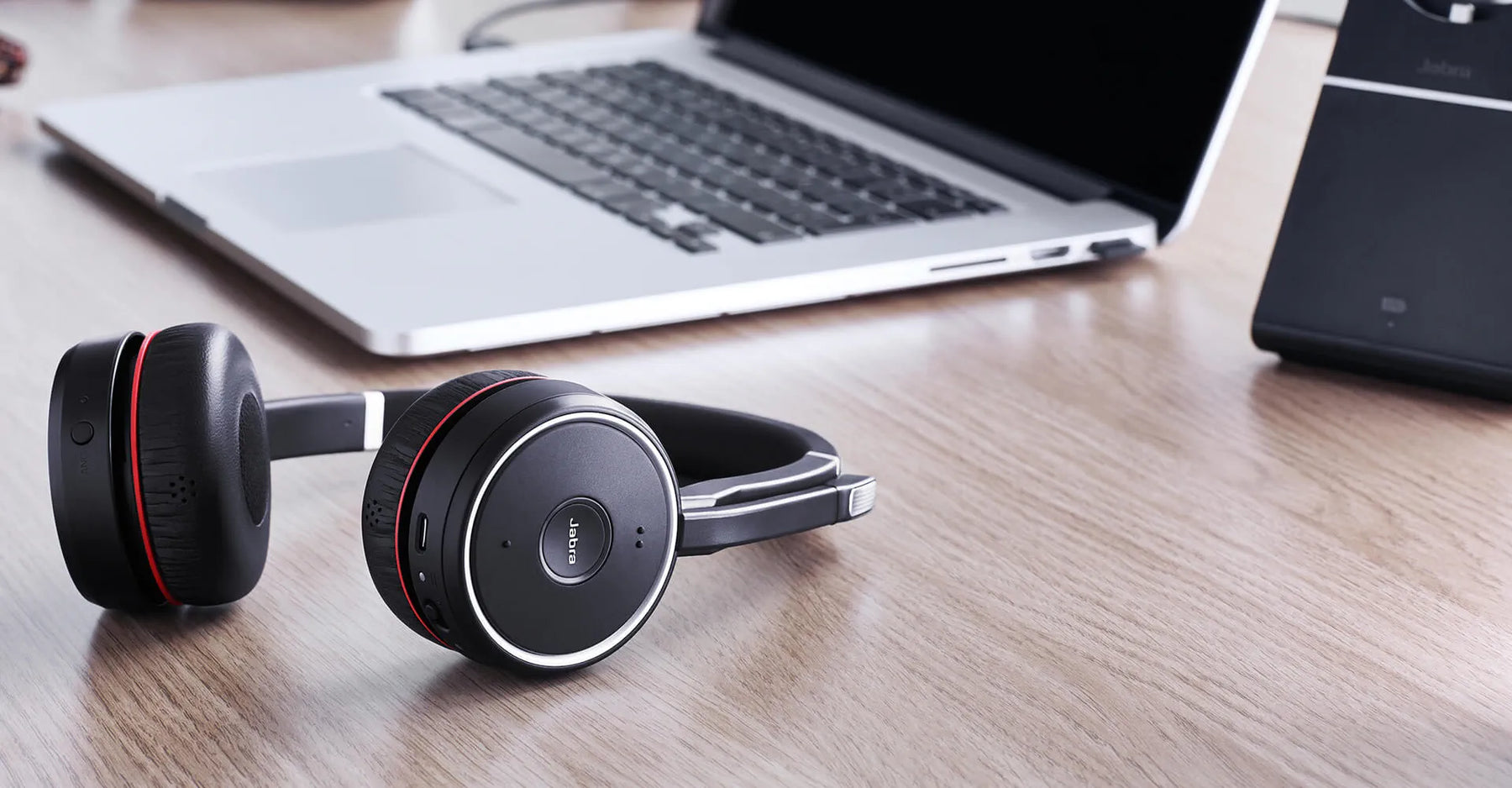 Jabra evolve headset on table next to laptop